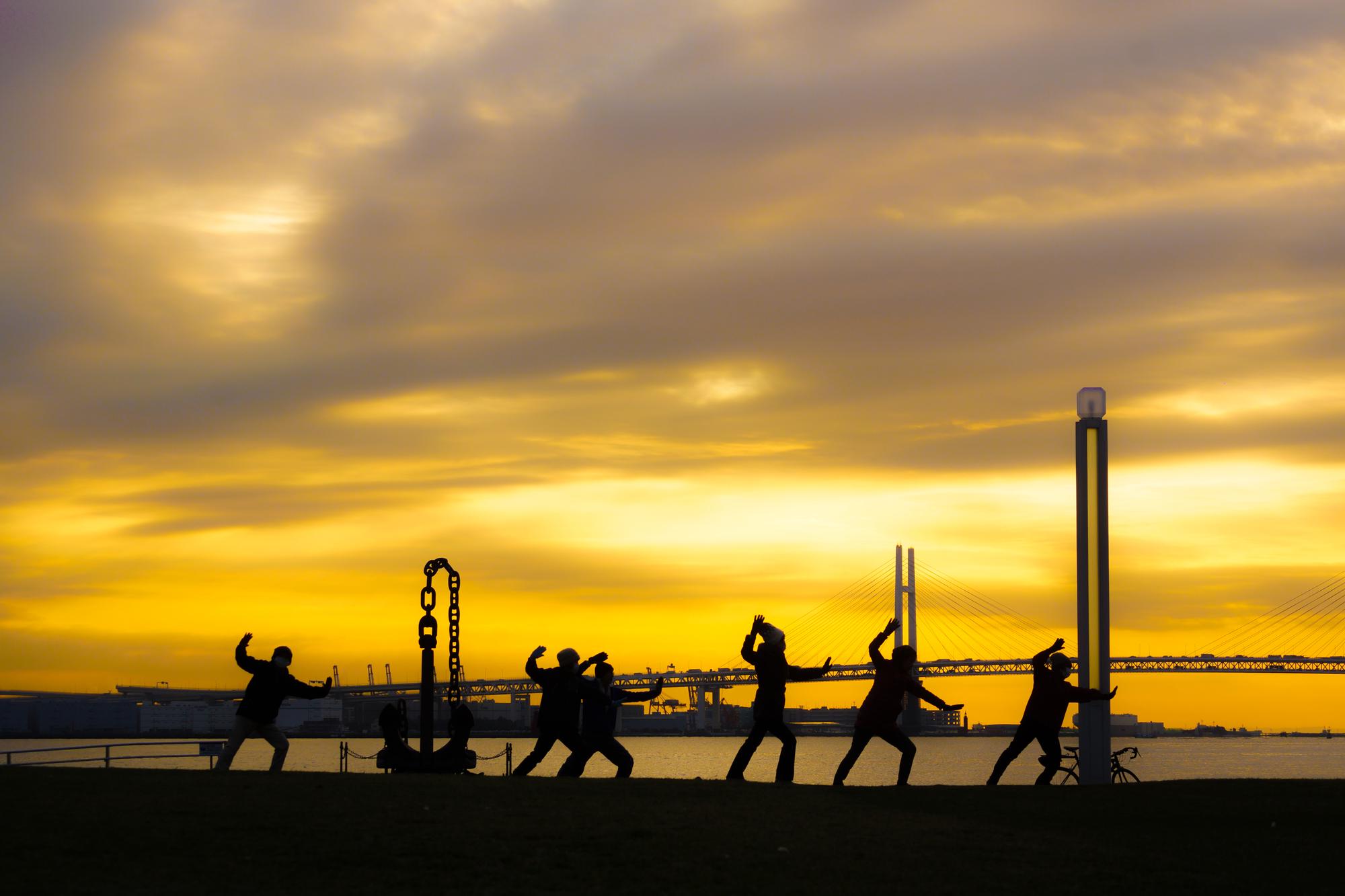 Crew operating on an offshore drilling rig at sunrise